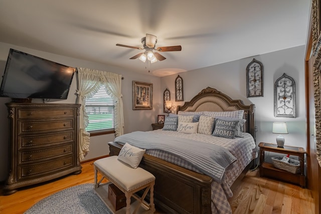 bedroom with light wood-style floors and a ceiling fan