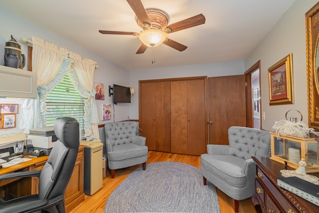 office space with a ceiling fan and light wood-style floors