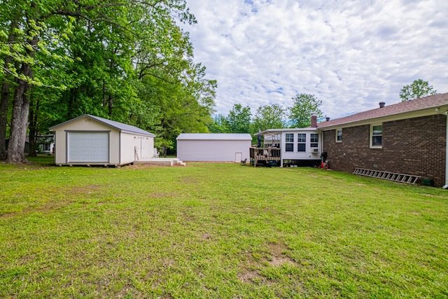 view of yard with a deck and an outbuilding