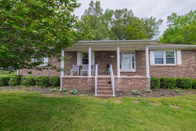 view of front of home featuring brick siding, a porch, and a front lawn