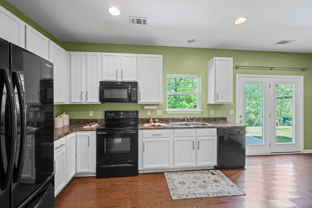 208 Wyburn Pl, Burns, TN 37029 - kitchen with visible vents, a sink, white cabinetry, and black appliances