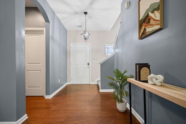 208 Wyburn Pl, Burns, TN 37029 - entrance foyer featuring arched walkways, baseboards, stairs, and wood finished floors