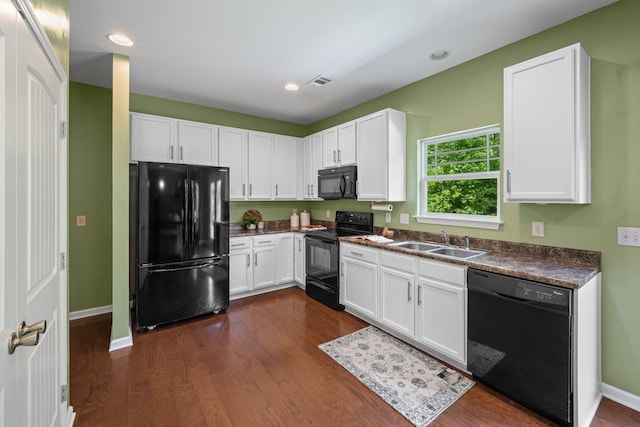 208 Wyburn Pl, Burns, TN 37029 - kitchen with dark wood-style flooring, dark countertops, a sink, black appliances, and white cabinetry