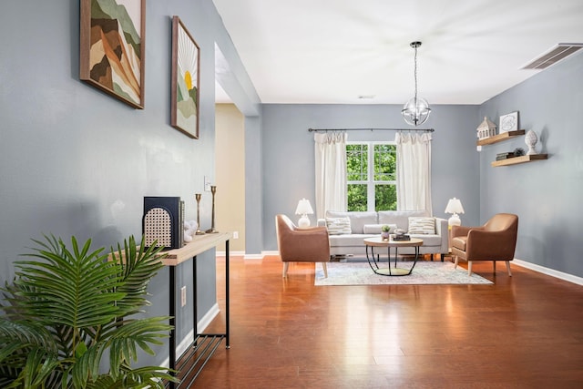 208 Wyburn Pl, Burns, TN 37029 - living area with a chandelier, baseboards, visible vents, and wood finished floors