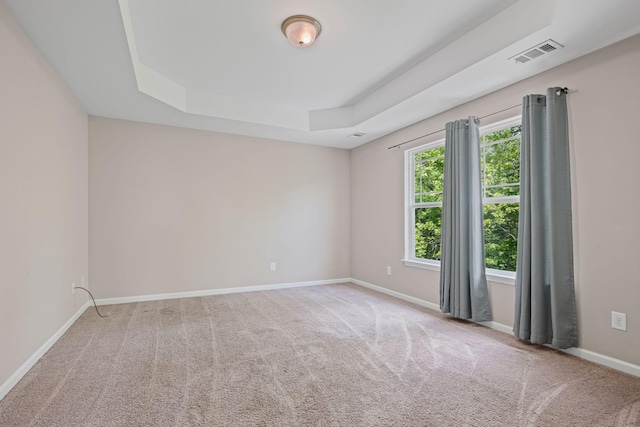 208 Wyburn Pl, Burns, TN 37029 - carpeted empty room featuring a tray ceiling, visible vents, and baseboards