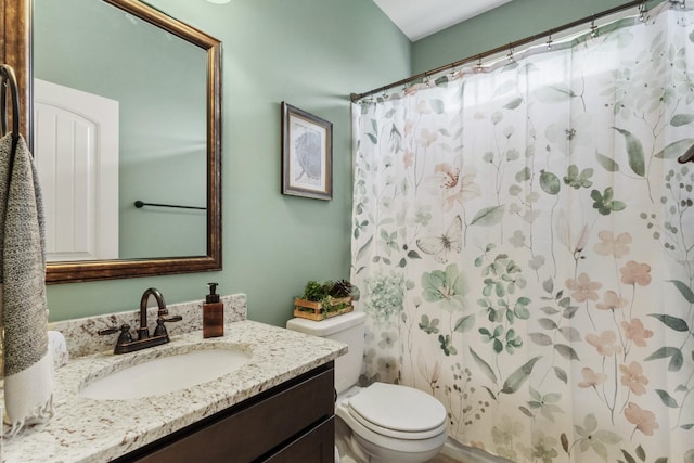 bathroom featuring vanity, curtained shower, and toilet
