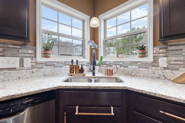 kitchen with stainless steel dishwasher, a sink, decorative backsplash, and a healthy amount of sunlight
