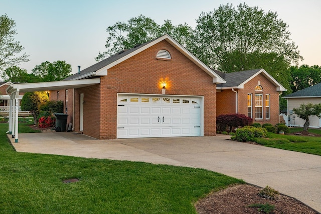 view of front facade with an attached garage, concrete driveway, a front lawn, and brick siding