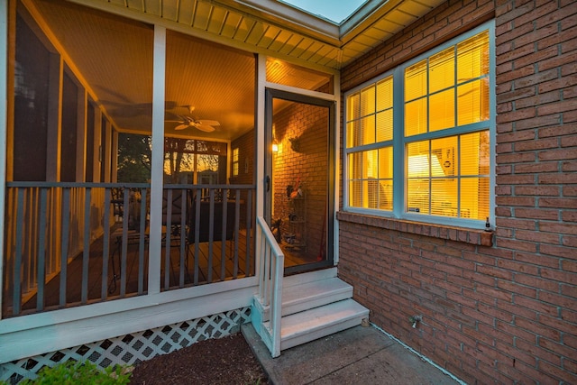 doorway to property featuring brick siding
