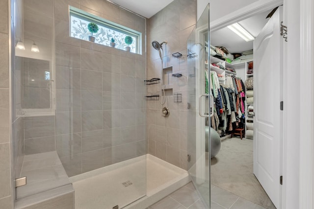 1072 Sumner Grv, Spring Hill, TN 37174 - bathroom featuring tile patterned floors, a tile shower, and a walk in closet