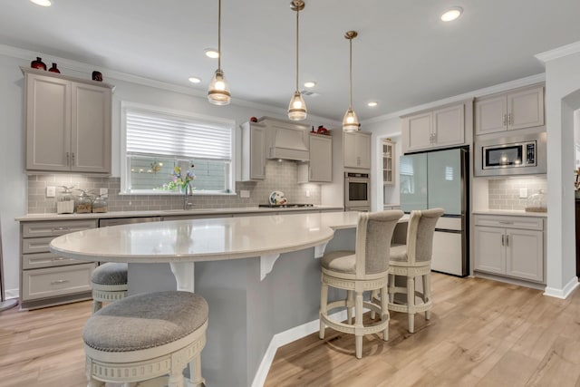 1072 Sumner Grv, Spring Hill, TN 37174 - kitchen featuring appliances with stainless steel finishes, a sink, gray cabinets, tasteful backsplash, and ornamental molding