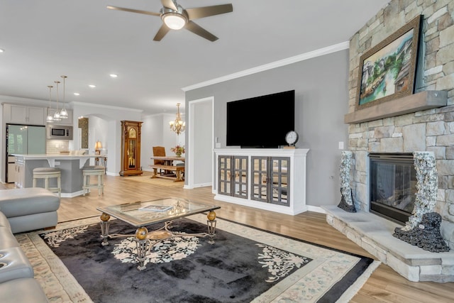 1072 Sumner Grv, Spring Hill, TN 37174 - living room with crown molding, arched walkways, light wood-type flooring, ceiling fan with notable chandelier, and recessed lighting
