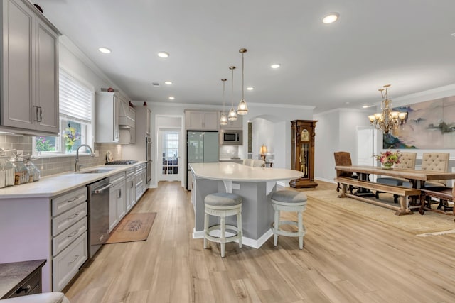 1072 Sumner Grv, Spring Hill, TN 37174 - kitchen featuring arched walkways, appliances with stainless steel finishes, gray cabinetry, and ornamental molding