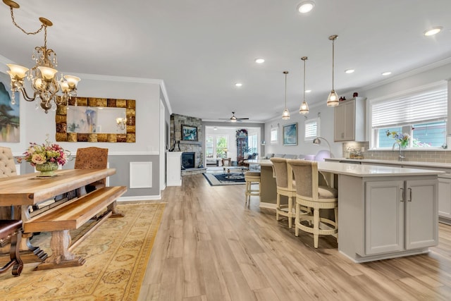 1072 Sumner Grv, Spring Hill, TN 37174 - kitchen featuring light countertops, crown molding, a kitchen island with sink, and recessed lighting