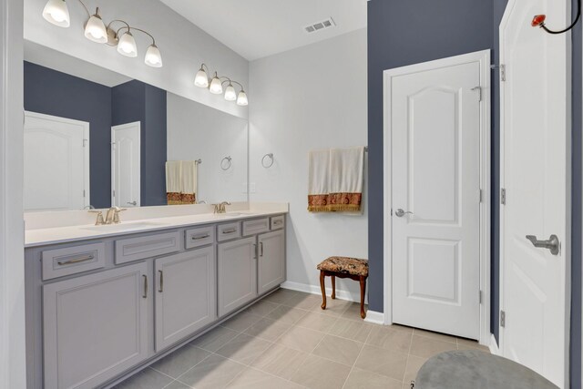 1072 Sumner Grv, Spring Hill, TN 37174 - bathroom with visible vents, tile patterned flooring, double vanity, baseboards, and a sink