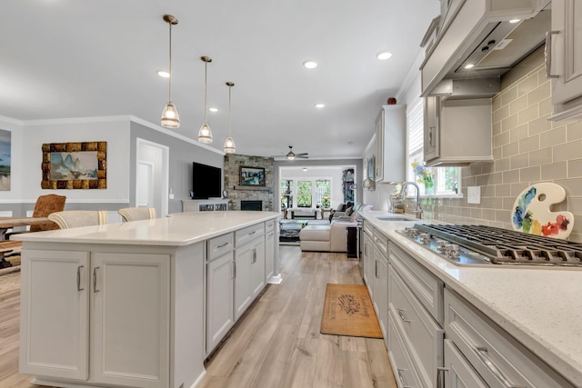 1072 Sumner Grv, Spring Hill, TN 37174 - kitchen featuring a sink, a fireplace, a center island, a ceiling fan, and open floor plan