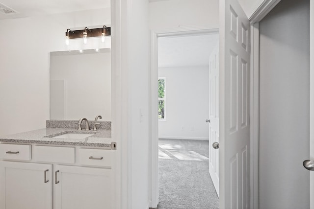 bathroom with visible vents, vanity, and baseboards