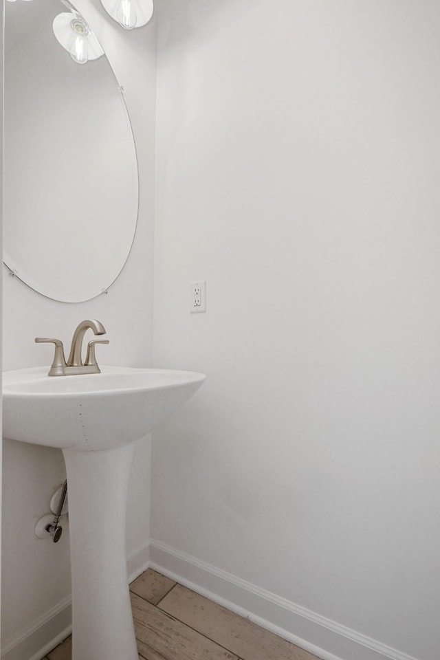 bathroom with baseboards and a sink