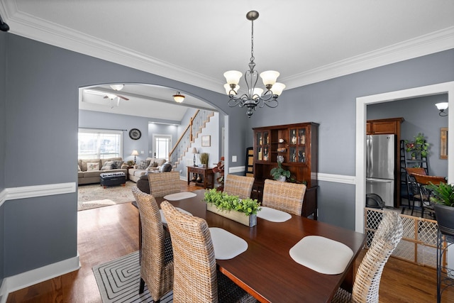 1341 Judge Tyler Dr, Clarksville, TN 37043 - dining space featuring stairway, crown molding, arched walkways, wood finished floors, and ceiling fan with notable chandelier
