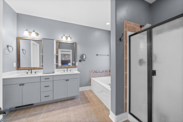 1341 Judge Tyler Dr, Clarksville, TN 37043 - full bath featuring tile patterned flooring, double vanity, a bath, a sink, and a stall shower
