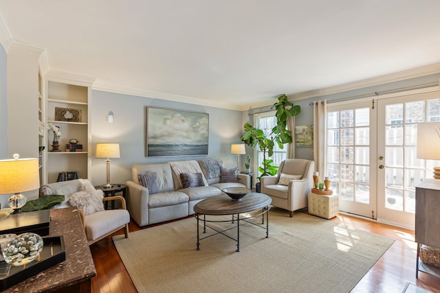 living area with ornamental molding, french doors, and wood finished floors
