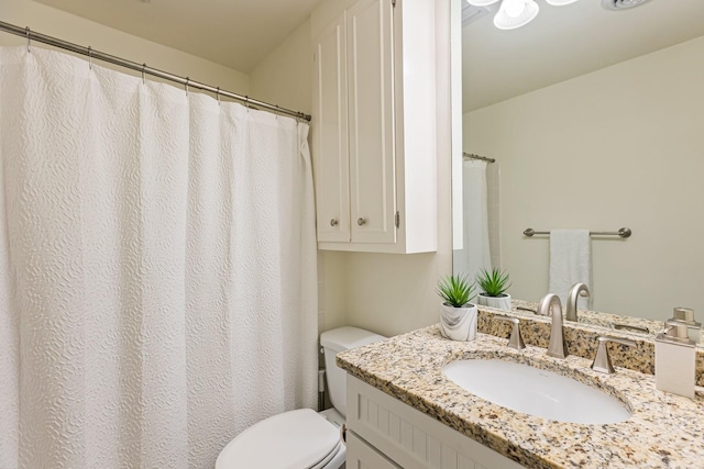 full bath featuring vanity and toilet