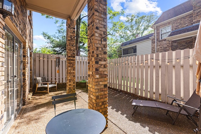 view of patio featuring fence