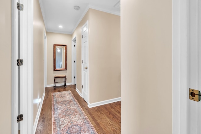 hall with dark wood finished floors, baseboards, crown molding, and recessed lighting