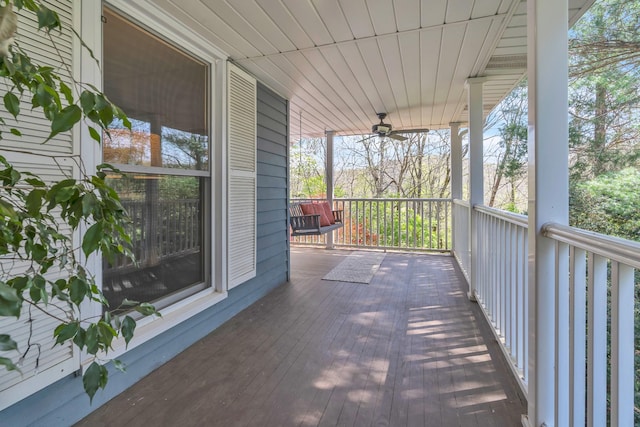 wooden terrace with a ceiling fan