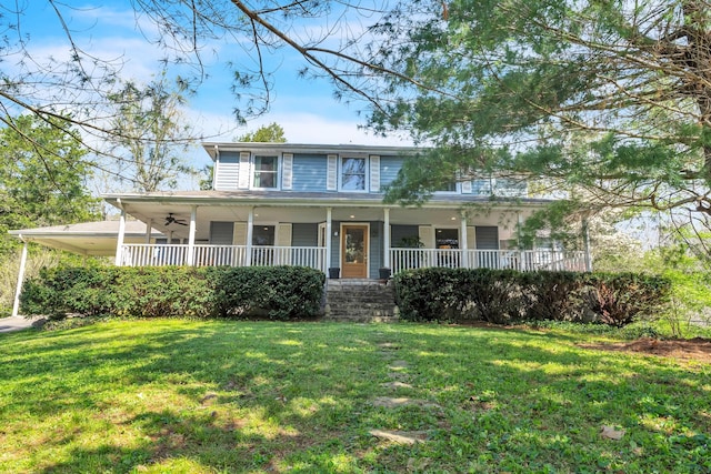 view of front of home with covered porch, ceiling fan, and a front yard