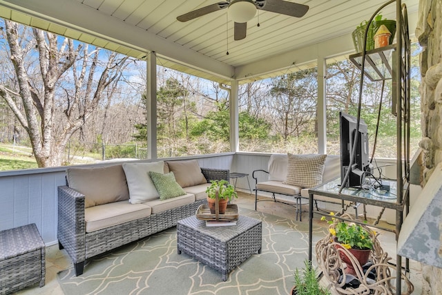 sunroom with an outdoor living space and a ceiling fan