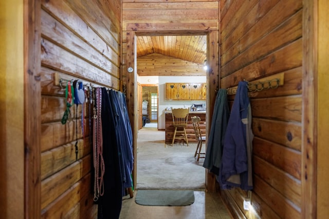 interior space featuring wood ceiling, wooden walls, vaulted ceiling, and carpet floors