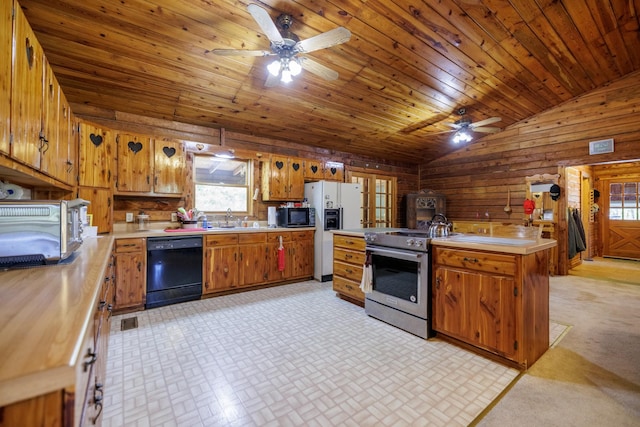 kitchen featuring light countertops, black appliances, a ceiling fan, wooden walls, and lofted ceiling