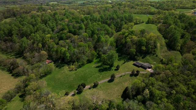 birds eye view of property featuring a wooded view