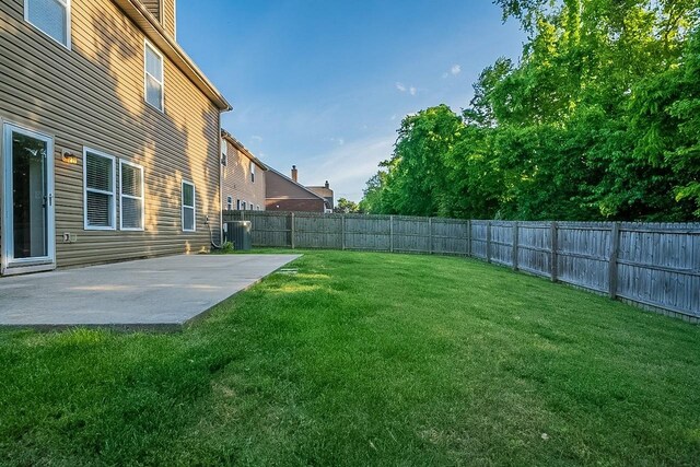 view of yard with a patio, a fenced backyard, and central AC unit