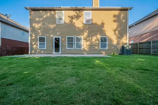 back of property with a patio, a yard, and a fenced backyard