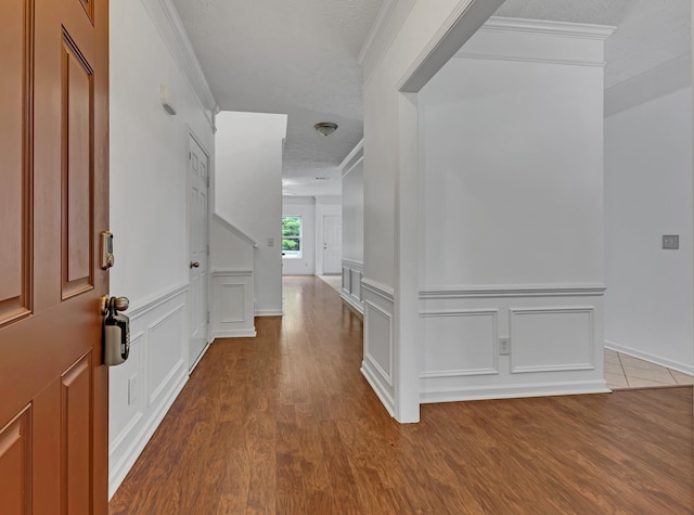 7347 Autumn Crossing Way, Brentwood, TN 37027 - foyer entrance featuring ornamental molding, wood finished floors, a decorative wall, and wainscoting