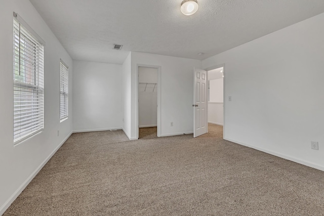 7347 Autumn Crossing Way, Brentwood, TN 37027 - unfurnished bedroom with carpet floors, baseboards, a spacious closet, a closet, and a textured ceiling