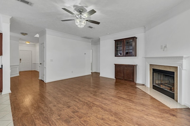 7347 Autumn Crossing Way, Brentwood, TN 37027 - unfurnished living room featuring ceiling fan, wood finished floors, a fireplace with flush hearth, and crown molding