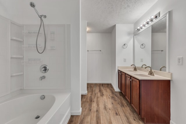 7347 Autumn Crossing Way, Brentwood, TN 37027 - bathroom with wood finished floors, double vanity, baseboards, a textured ceiling, and tub / shower combination