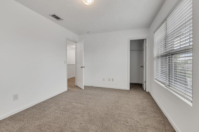 7347 Autumn Crossing Way, Brentwood, TN 37027 - unfurnished bedroom with carpet flooring, a walk in closet, baseboards, and a closet
