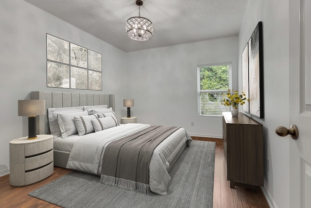7347 Autumn Crossing Way, Brentwood, TN 37027 - bedroom with a chandelier, wood finished floors, a textured ceiling, and baseboards