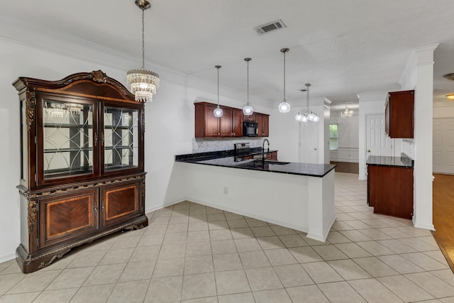 7347 Autumn Crossing Way, Brentwood, TN 37027 - kitchen with a chandelier, dark countertops, a sink, crown molding, and a peninsula