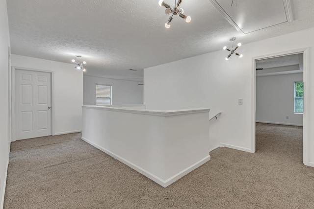 7347 Autumn Crossing Way, Brentwood, TN 37027 - corridor with attic access, an upstairs landing, carpet, a textured ceiling, and healthy amount of natural light
