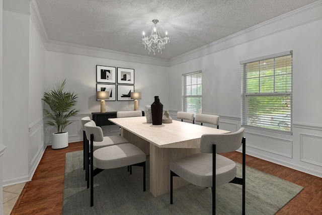 7347 Autumn Crossing Way, Brentwood, TN 37027 - dining room featuring a textured ceiling, a chandelier, ornamental molding, wood finished floors, and a decorative wall