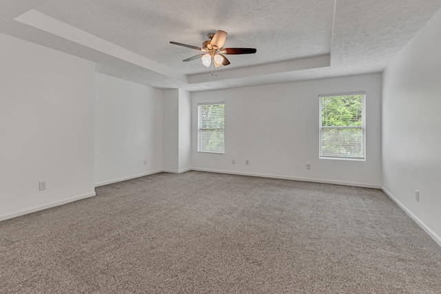 7347 Autumn Crossing Way, Brentwood, TN 37027 - carpeted empty room featuring a textured ceiling, a raised ceiling, healthy amount of natural light, ceiling fan, and baseboards