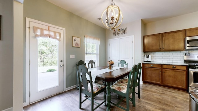 524 Burchell Ln, Columbia, TN 38401 - dining space featuring baseboards, light wood-type flooring, and a chandelier