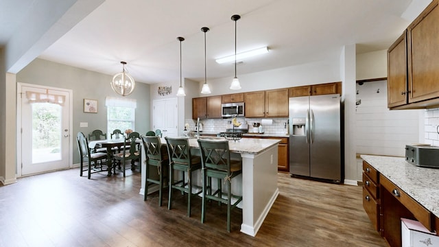 524 Burchell Ln, Columbia, TN 38401 - kitchen with pendant lighting, dark wood-style flooring, a breakfast bar area, tasteful backsplash, and appliances with stainless steel finishes