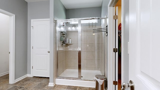524 Burchell Ln, Columbia, TN 38401 - bathroom with baseboards, a spacious closet, and a shower stall
