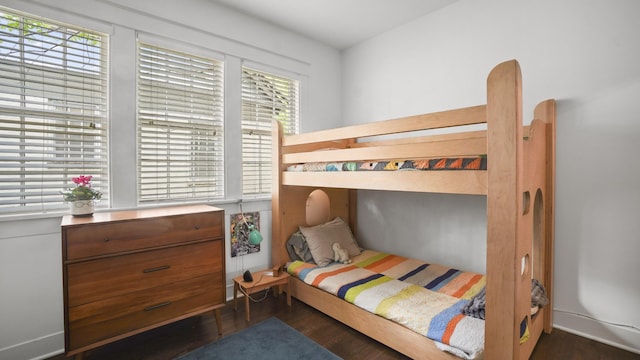 bedroom with dark wood finished floors